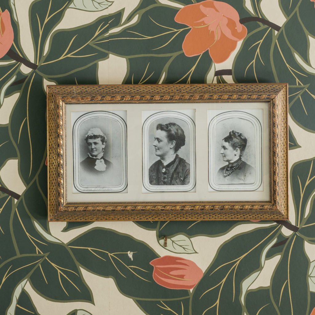 Two large silhouettes and three small black and white photographs.