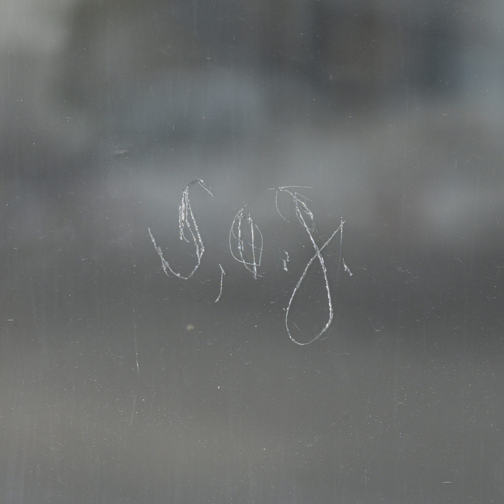 the letters S O J etched into glass